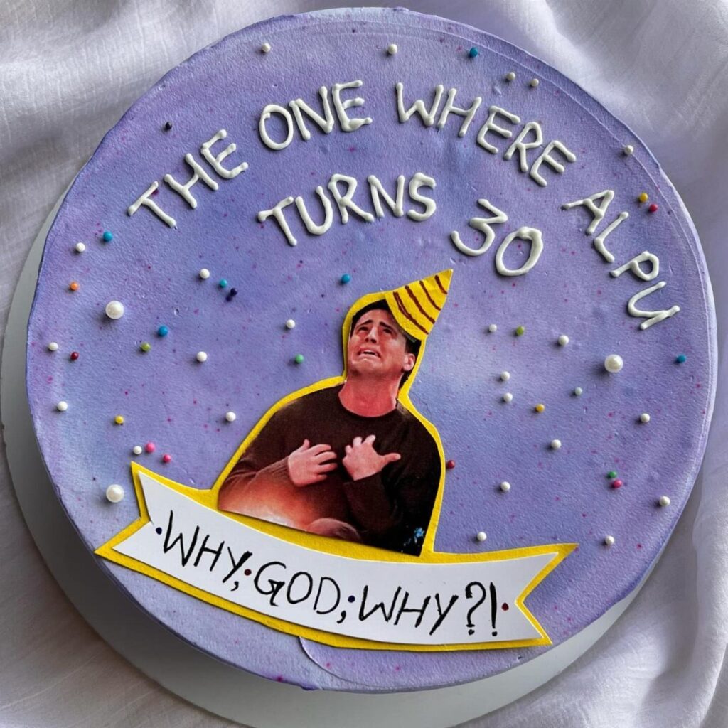 Purple birthday cake with white icing text and a funny printed character image.