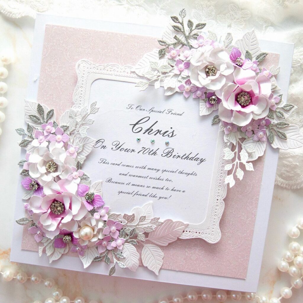 Handmade 70th birthday card with pink 3D flowers and silver glitter accents.