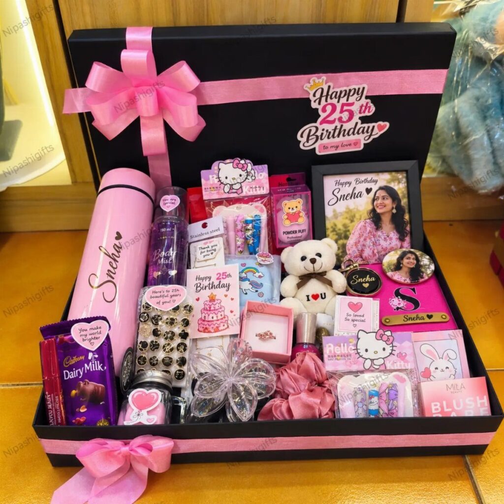 Gift hamper for a 25th birthday featuring pink accessories, chocolates, and a framed photo.