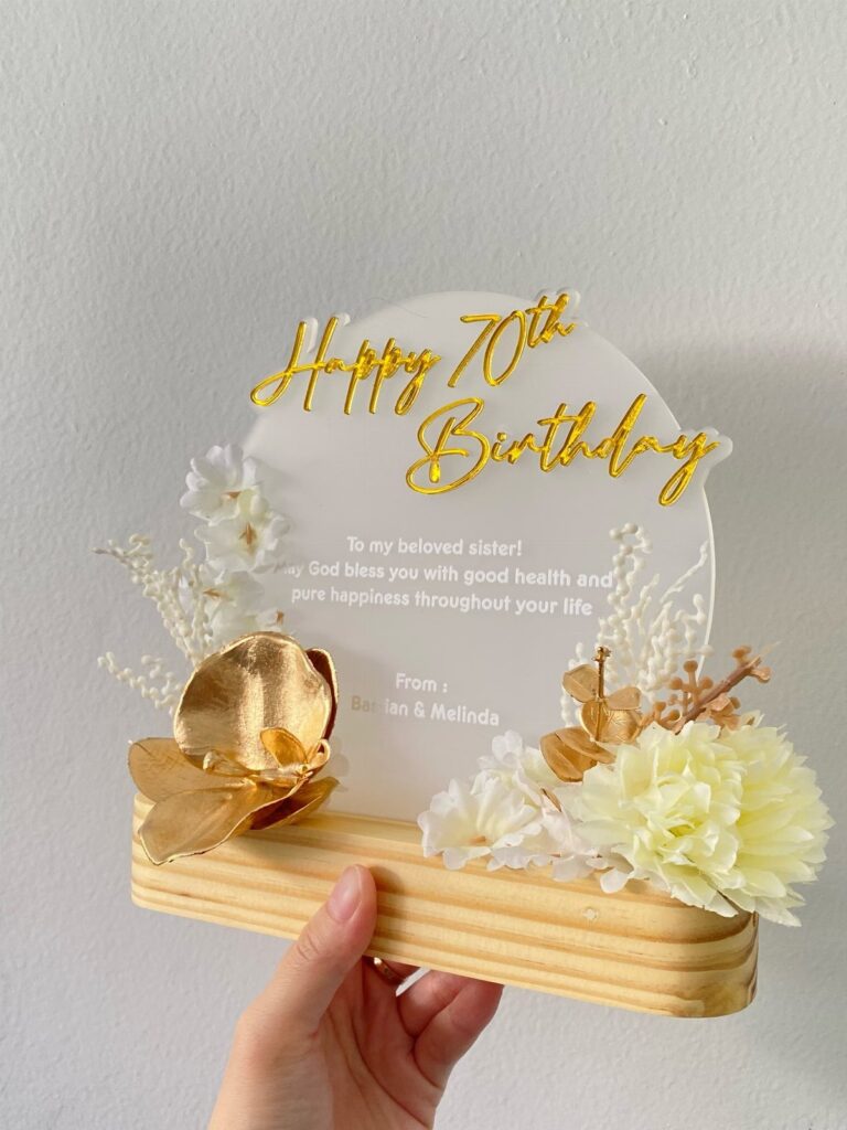 Birthday plaque for a 70th birthday sister with gold glitter text and flowers