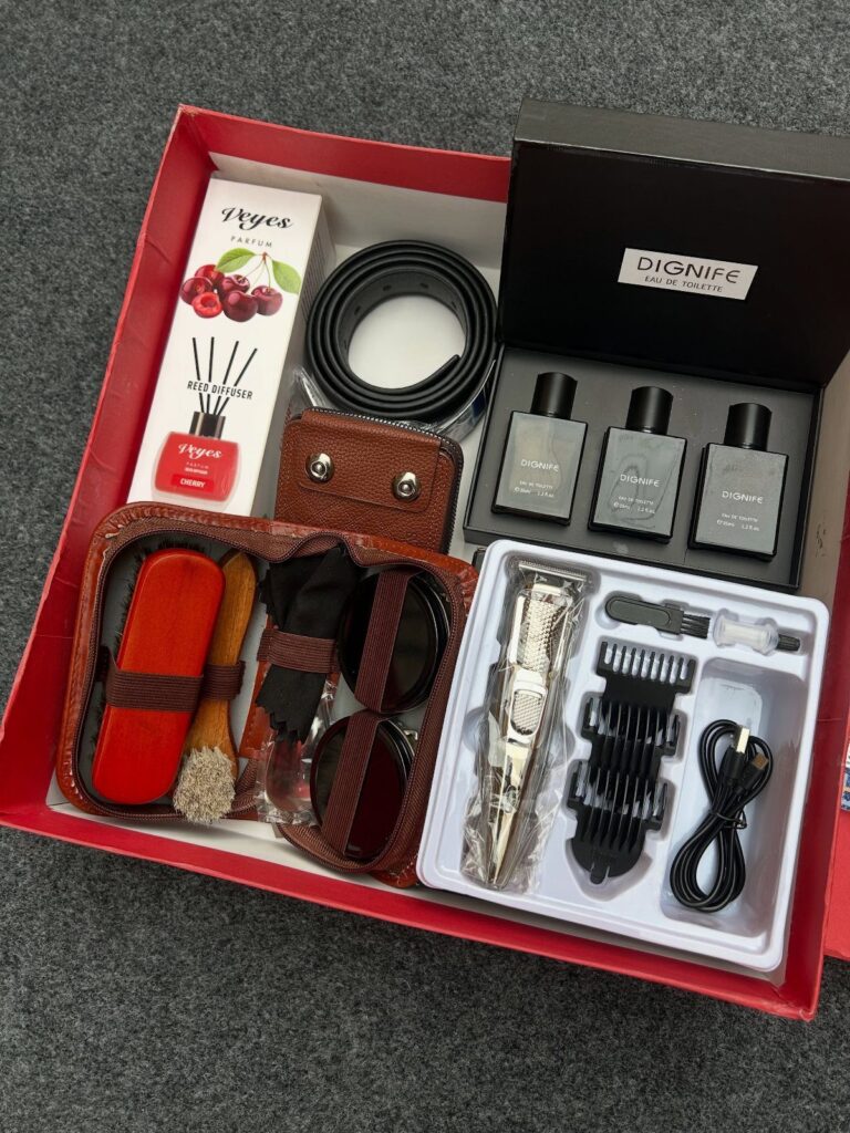 Men's grooming and accessory gift set in a red box with fragrance and belt.