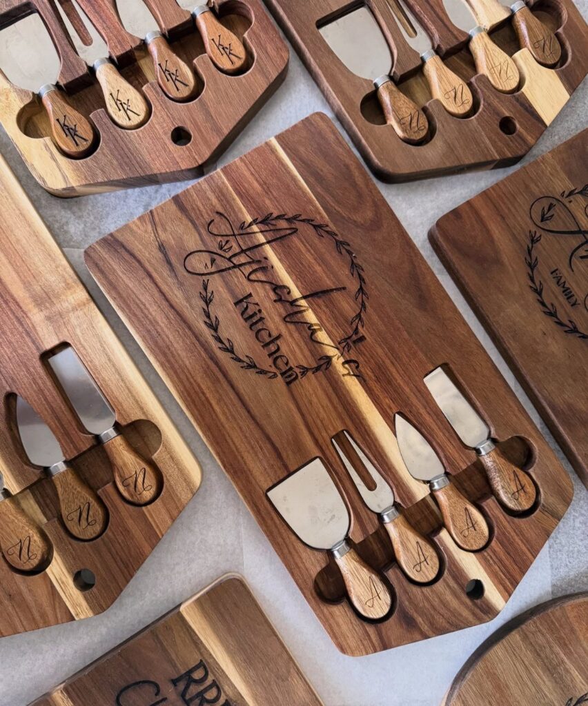Engraved wooden chopping blocks with matching cheese knife sets in built-in slots.