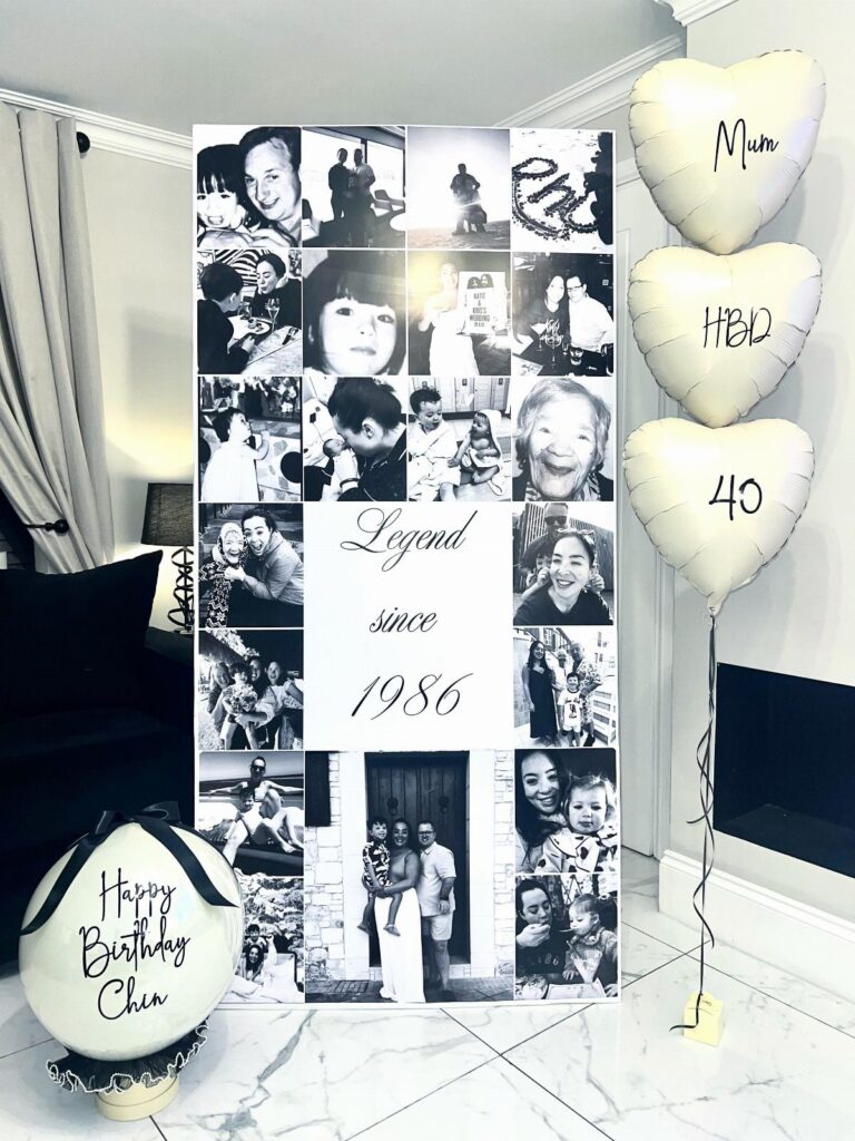 Birthday celebration setup with a photo collage banner and white heart-shaped balloons.